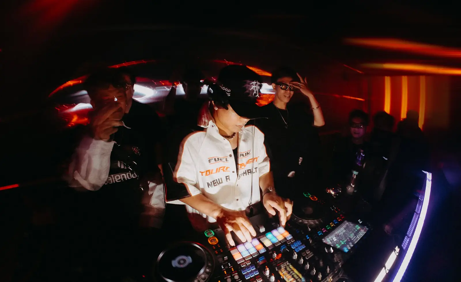 DJ đội mũ chơi nhạc trên bàn mix, khách đứng sát quanh bốt tại Drave Club
